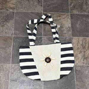 black and white striped tote bag with a floral accent.